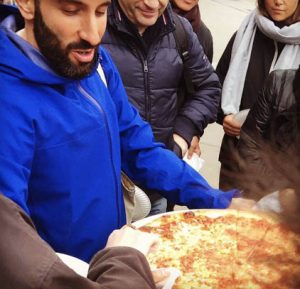 Tour Guide holding pizza